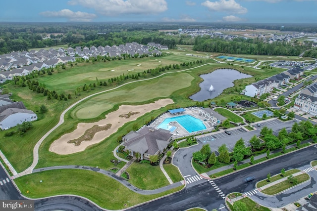drone / aerial view featuring view of golf course, a water view, and a residential view