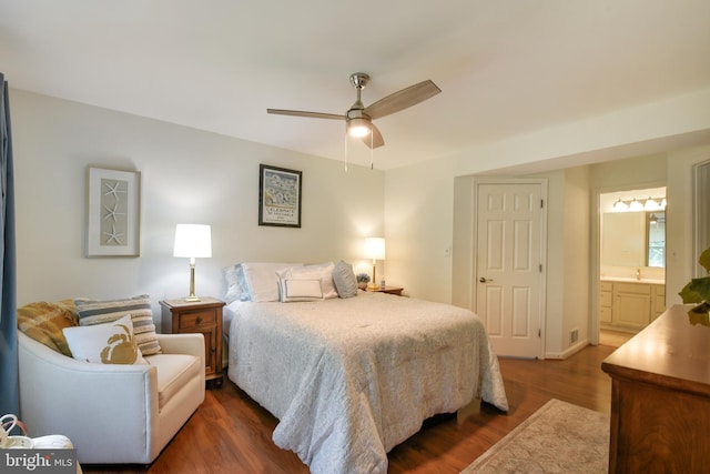 bedroom with ensuite bathroom, a ceiling fan, and dark wood-style floors