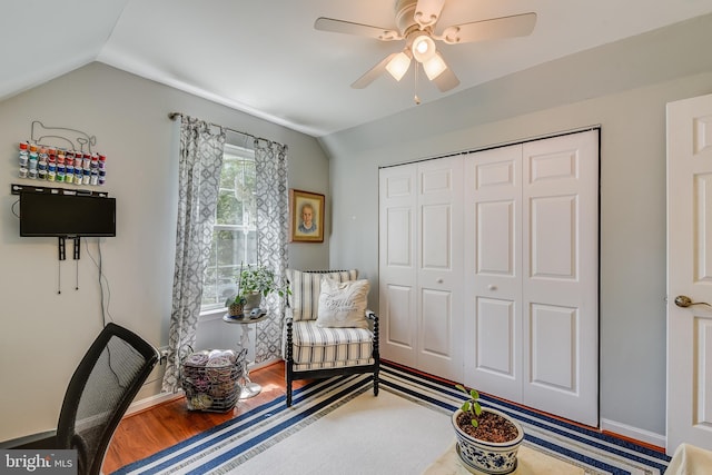 sitting room featuring baseboards, ceiling fan, wood finished floors, and lofted ceiling