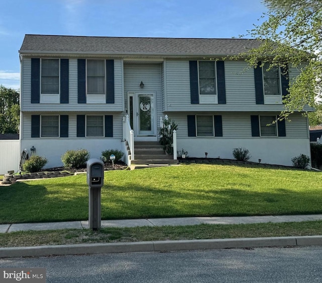 raised ranch with a front lawn