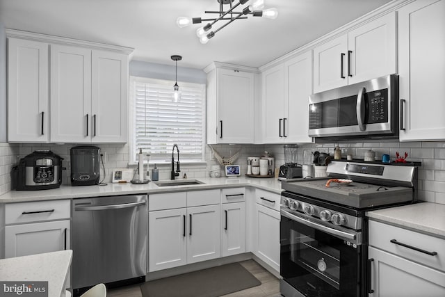 1694 Atkins Ave, Thorofare, NJ 08086 - kitchen with appliances with stainless steel finishes, a sink, white cabinets, backsplash, and light countertops