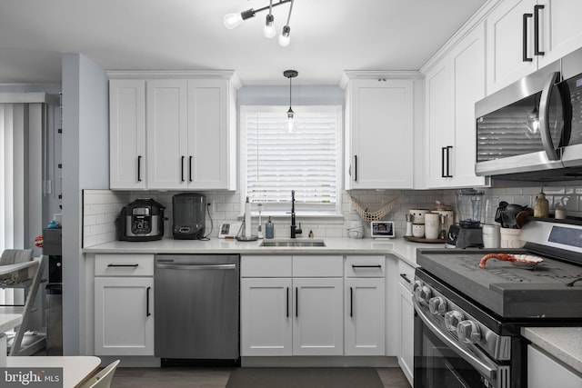 1694 Atkins Ave, Thorofare, NJ 08086 - kitchen with stainless steel appliances, a sink, white cabinetry, light countertops, and decorative backsplash