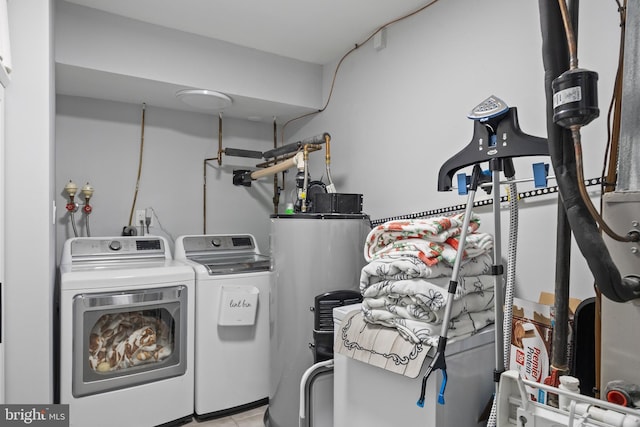 1694 Atkins Ave, Thorofare, NJ 08086 - clothes washing area featuring washing machine and dryer, water heater, and tile patterned floors