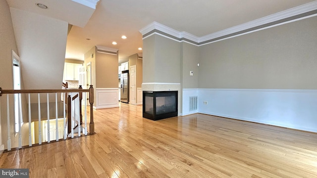 11441 Log Ridge Dr, Fairfax, VA 22030 - unfurnished living room with crown molding, light wood-style flooring, recessed lighting, and a multi sided fireplace