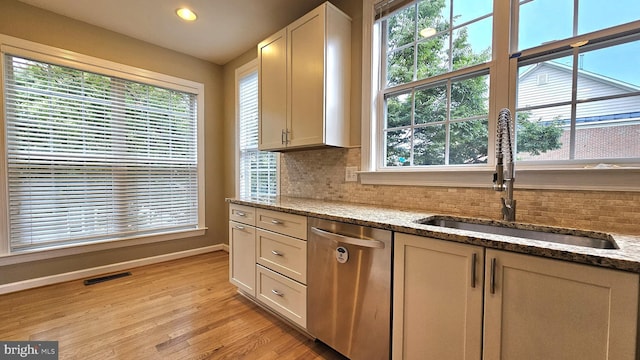 11441 Log Ridge Dr, Fairfax, VA 22030 - kitchen with stainless steel dishwasher, a sink, baseboards, decorative backsplash, and light wood finished floors