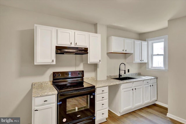 472 Atlantic Ave, Lancaster, PA 17602 - kitchen featuring light wood finished floors, a sink, black / electric stove, white cabinets, and under cabinet range hood