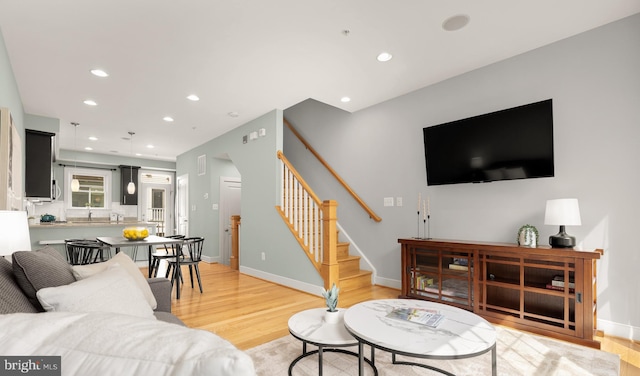 631 Regent Pl NE, Washington, DC 20017 - living area with light wood-type flooring, stairway, recessed lighting, and baseboards