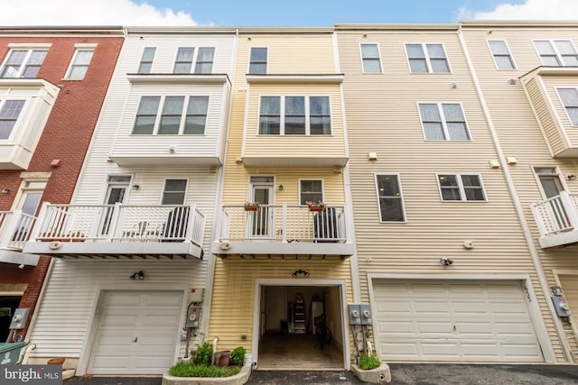 631 Regent Pl NE, Washington, DC 20017 - view of front of house featuring an attached garage, driveway, and a balcony