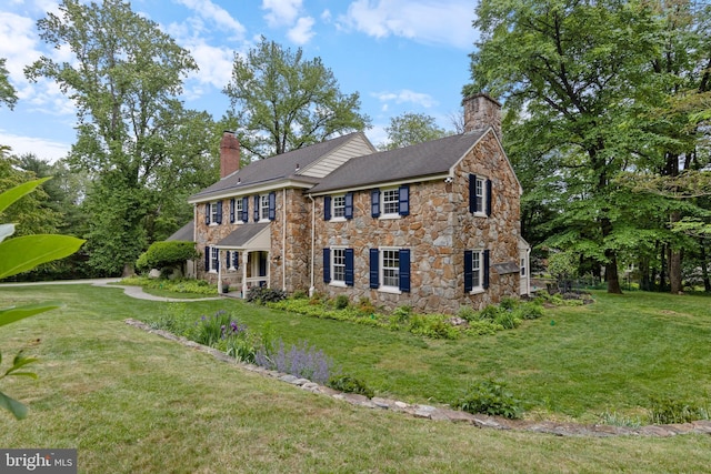 1409 Beaumont Dr, Gladwyne, PA 19035 - view of front of house with stone siding, a chimney, and a front lawn