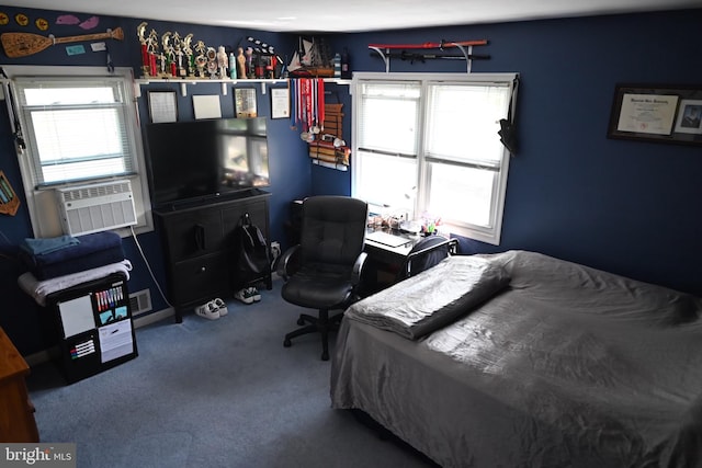bedroom featuring multiple windows, carpet floors, cooling unit, and a desk