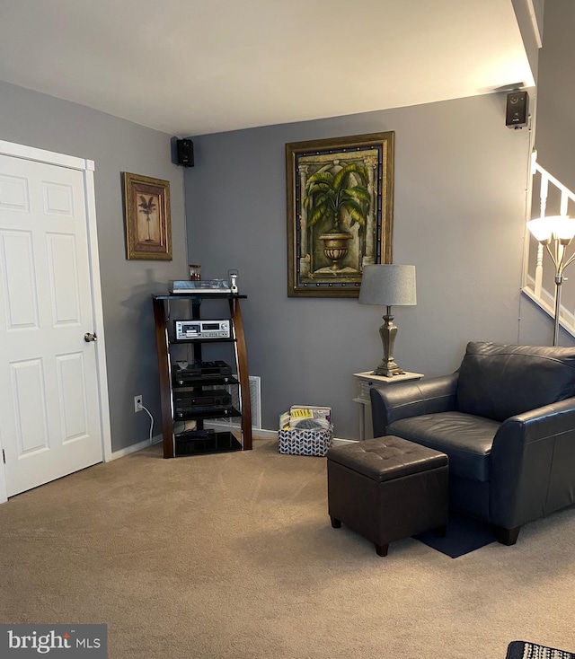 living area with baseboards and carpet