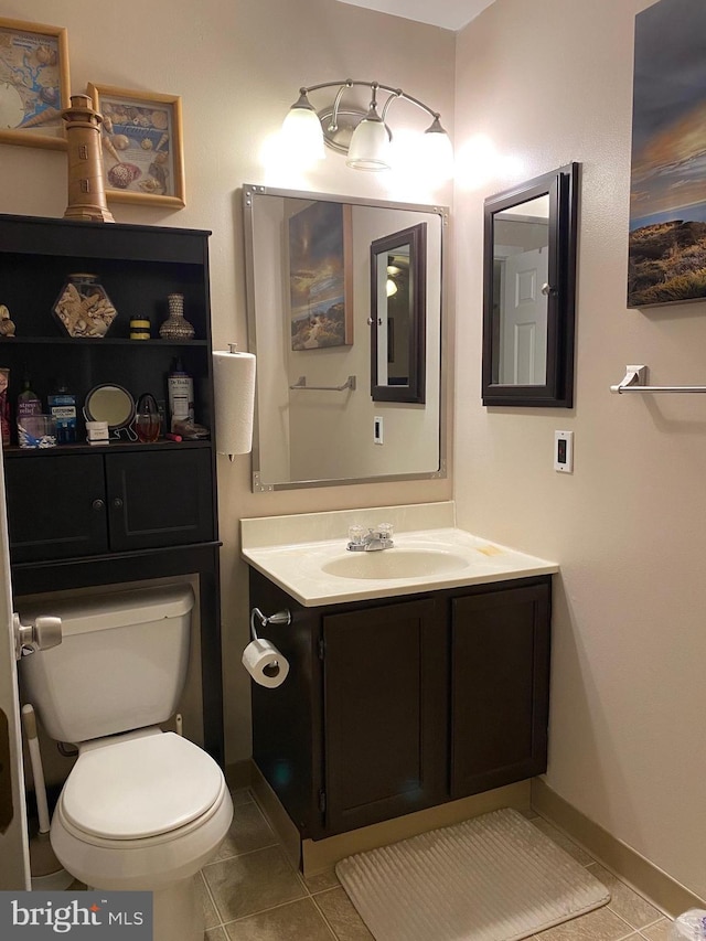 half bath featuring toilet, tile patterned flooring, and vanity