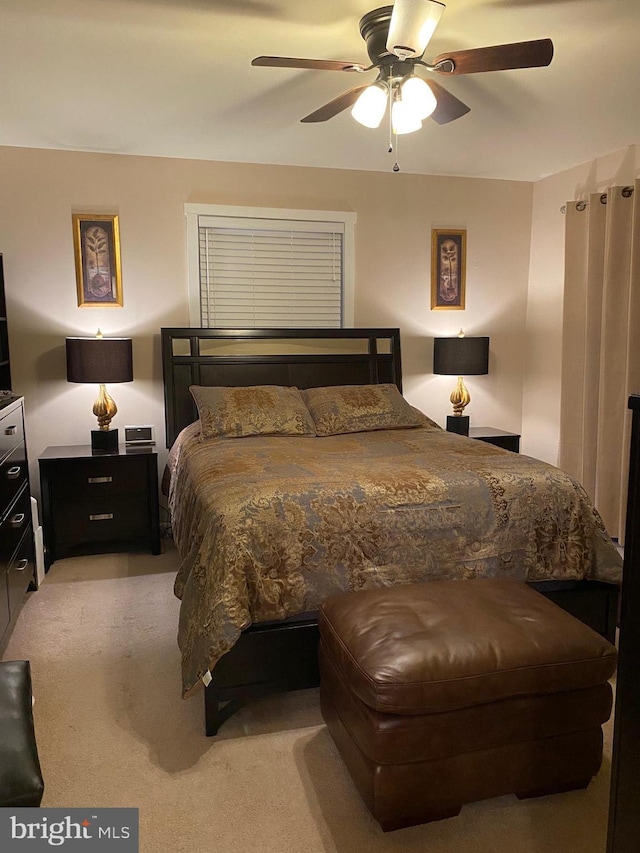 bedroom with ceiling fan and light carpet