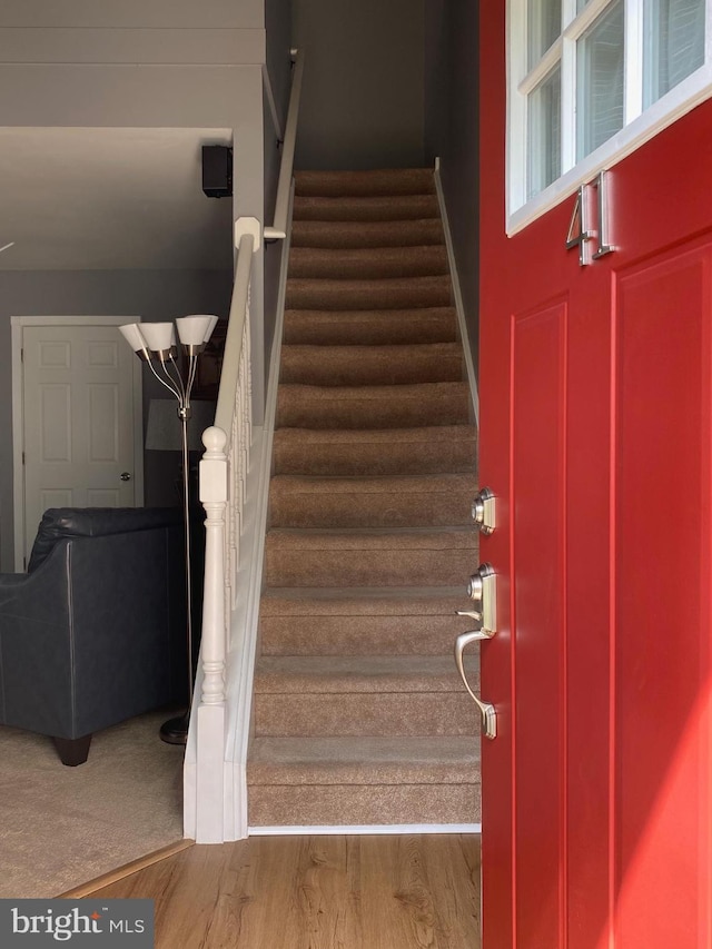 stairs featuring wood finished floors