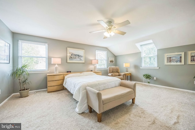 carpeted bedroom with baseboards, ceiling fan, and vaulted ceiling