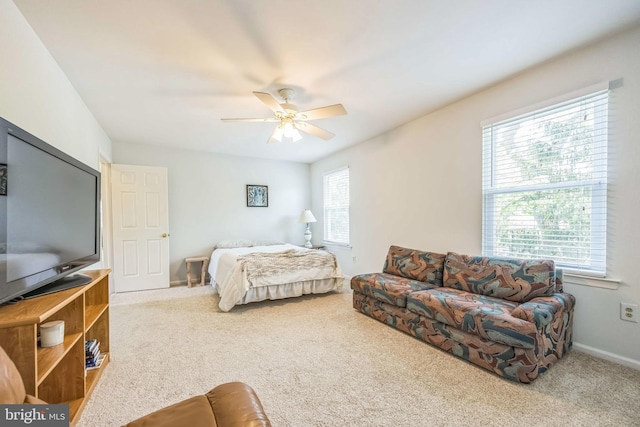 carpeted bedroom featuring a ceiling fan and baseboards