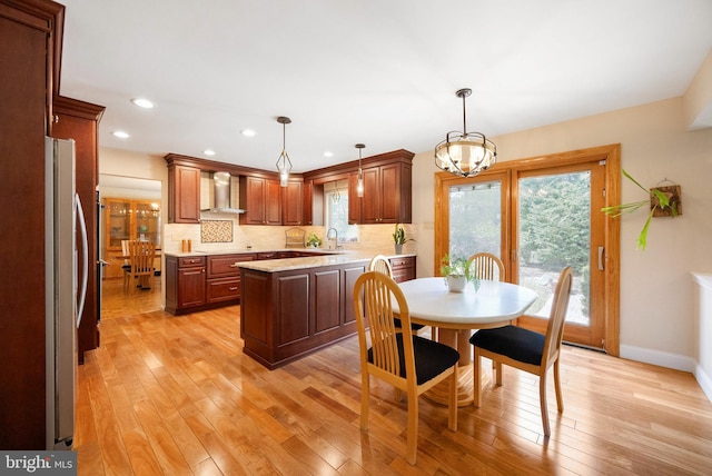 dining space featuring recessed lighting, light wood-type flooring, baseboards, and a chandelier