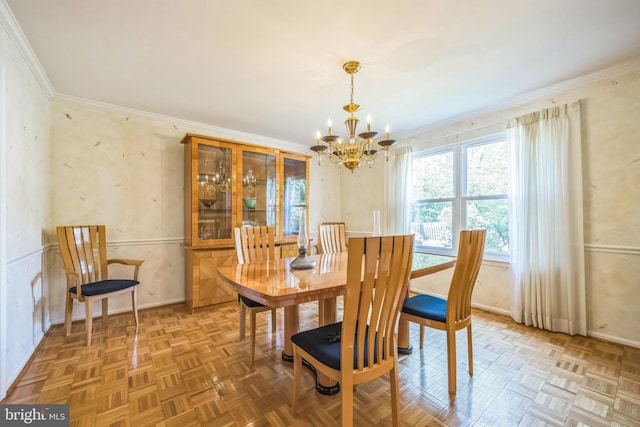 dining space featuring ornamental molding, a chandelier, and baseboards