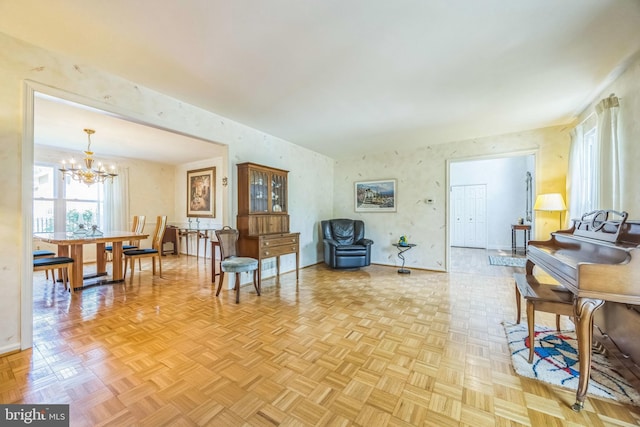living room with a chandelier and baseboards