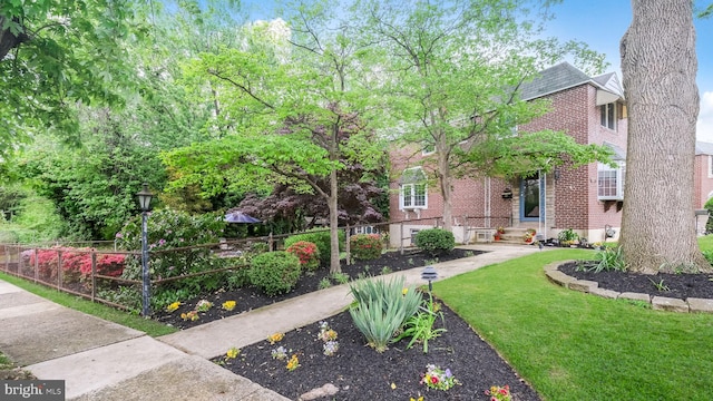 100 Lakeview Dr, Ridley Park, PA 19078 - view of front of house featuring brick siding, a front lawn, and fence