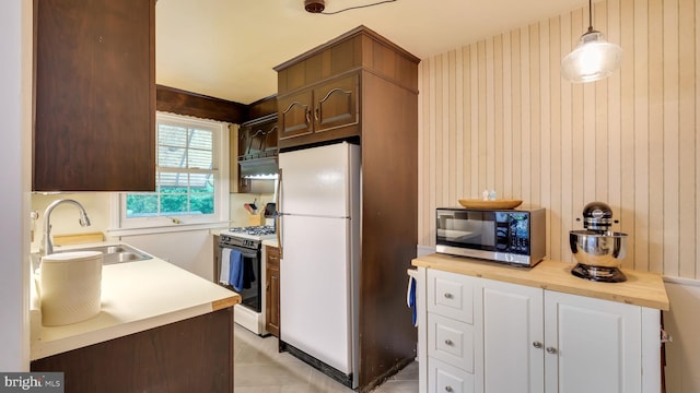 100 Lakeview Dr, Ridley Park, PA 19078 - kitchen with stainless steel microwave, a sink, freestanding refrigerator, butcher block counters, and gas range
