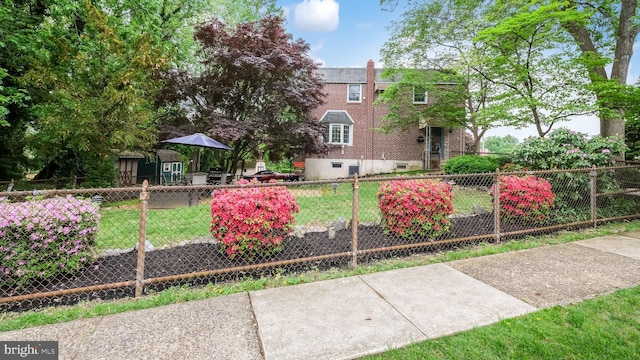 100 Lakeview Dr, Ridley Park, PA 19078 - exterior space with a chimney, a front yard, brick siding, and a fenced front yard