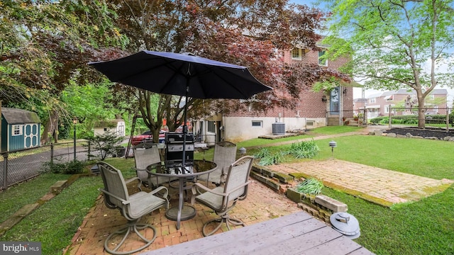 100 Lakeview Dr, Ridley Park, PA 19078 - view of patio featuring an outbuilding, outdoor dining area, fence, and a storage unit
