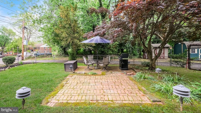 100 Lakeview Dr, Ridley Park, PA 19078 - view of patio featuring an outdoor structure, area for grilling, fence, and a storage unit