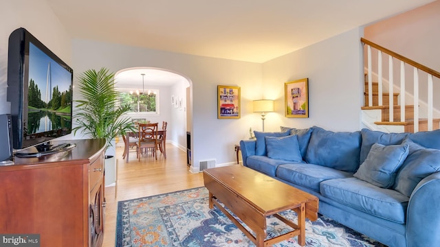 100 Lakeview Dr, Ridley Park, PA 19078 - living area with visible vents, baseboards, arched walkways, light wood-style floors, and stairs