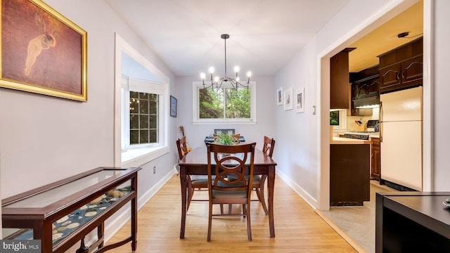 100 Lakeview Dr, Ridley Park, PA 19078 - dining room with light wood finished floors, baseboards, and a notable chandelier