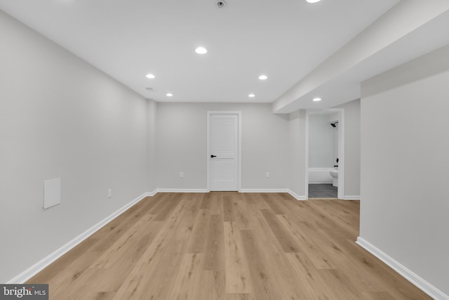 finished below grade area with light wood-style flooring, baseboards, and recessed lighting