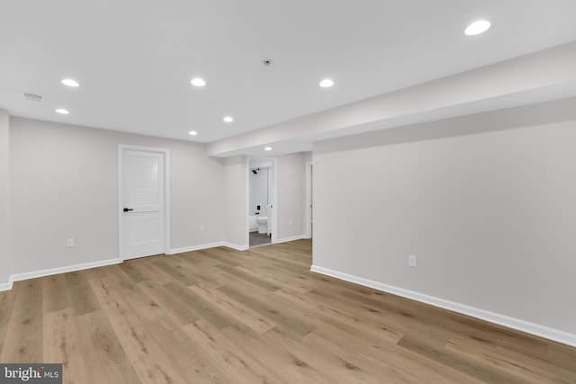 finished below grade area with baseboards, light wood finished floors, recessed lighting, and visible vents