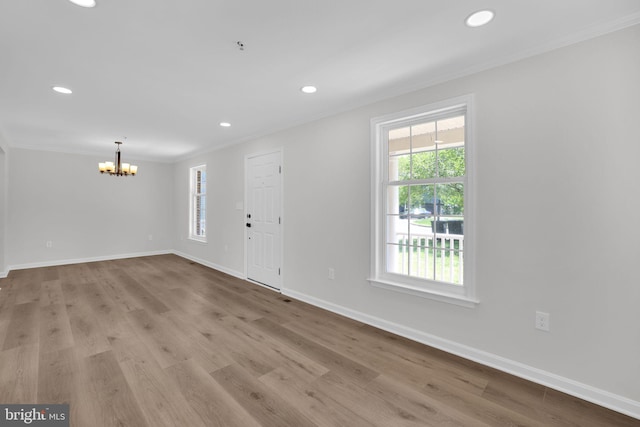 foyer entrance with recessed lighting, an inviting chandelier, crown molding, and plenty of natural light