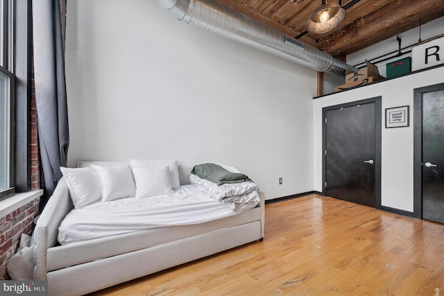 living area featuring visible vents and wood finished floors