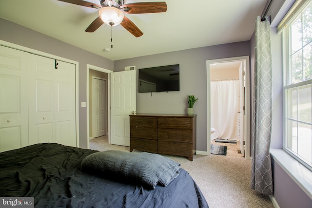 carpeted bedroom featuring ceiling fan, visible vents, baseboards, a closet, and connected bathroom