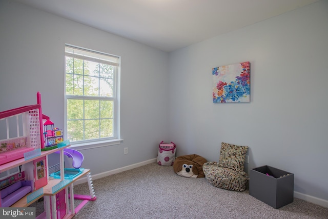 rec room featuring a healthy amount of sunlight, baseboards, and carpet flooring