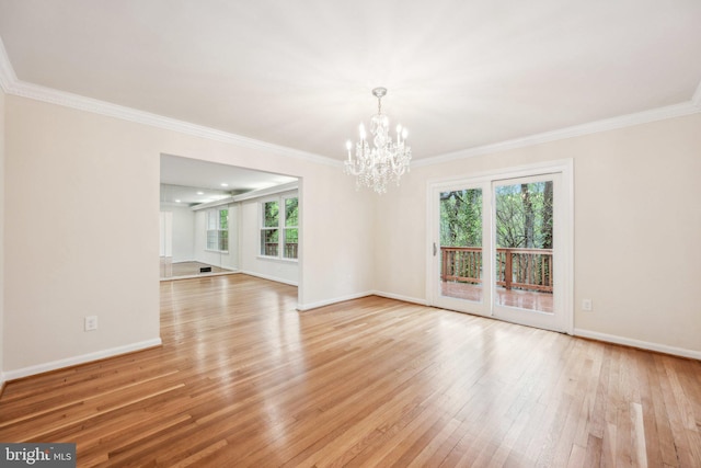 interior space with light wood-type flooring, baseboards, crown molding, and an inviting chandelier