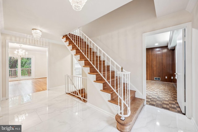 stairs featuring an inviting chandelier, marble finish floor, baseboards, and visible vents