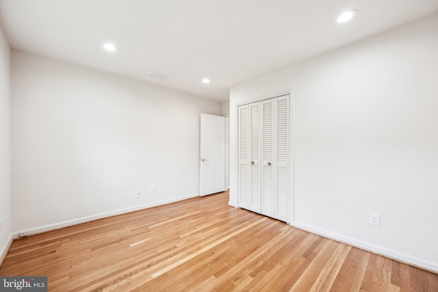 unfurnished bedroom featuring baseboards, recessed lighting, and wood finished floors