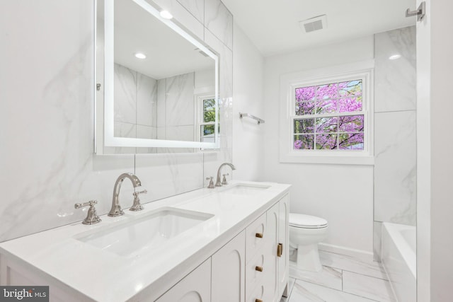 full bathroom with visible vents, a sink, marble finish floor, and toilet