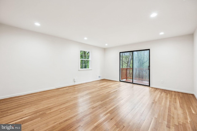 spare room with recessed lighting, baseboards, light wood-type flooring, and visible vents