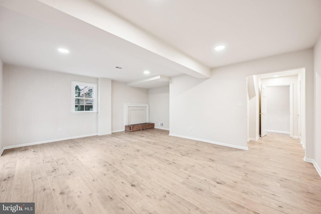 below grade area with baseboards, recessed lighting, and light wood-style flooring