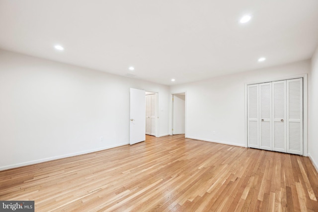 unfurnished bedroom featuring recessed lighting, baseboards, and light wood-style floors