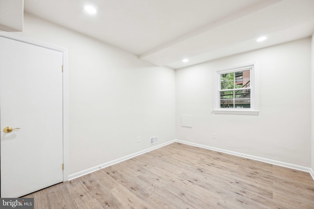 empty room with light wood-style floors, baseboards, recessed lighting, and visible vents