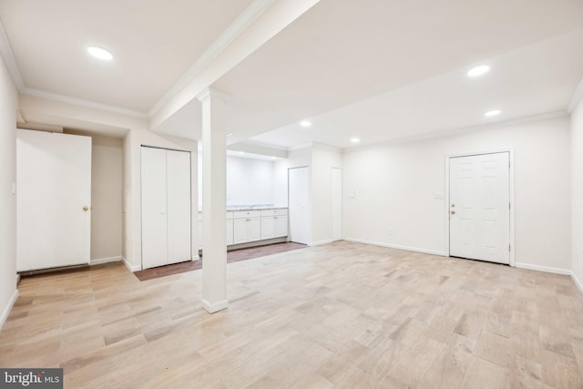 basement featuring ornamental molding, recessed lighting, and light wood-style flooring