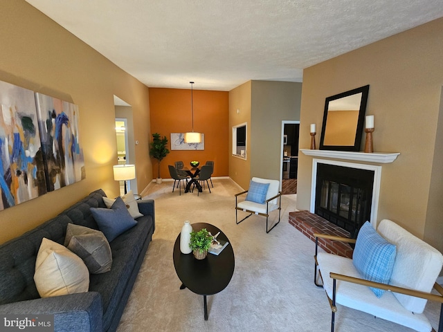 carpeted living room featuring baseboards and a glass covered fireplace