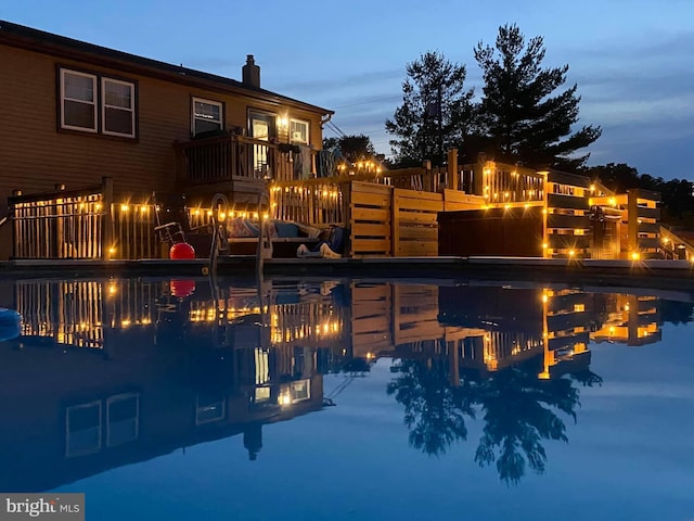exterior space featuring a fire pit, an outdoor pool, and a chimney