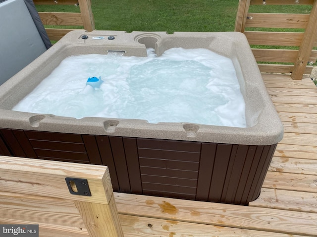 deck featuring an outdoor hot tub