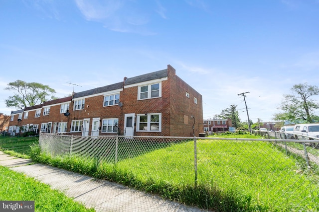 rear view of house featuring fence private yard and brick siding