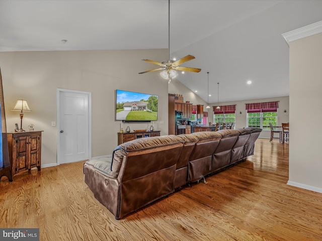 living area featuring light wood finished floors, a ceiling fan, recessed lighting, baseboards, and high vaulted ceiling